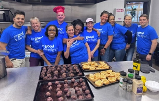 Guest Chef volunteers gathered around trays of prepared food at Ronald McDonald House Tulsa.