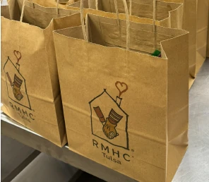 Prepared Lunches with Love bags displaying the Ronald McDonald House Tulsa logo.