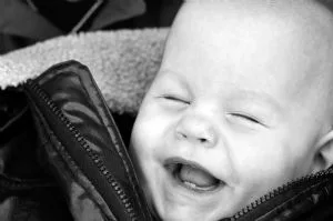 A smiling baby representing honorarium and memorial gifts that support Ronald McDonald House Tulsa families.