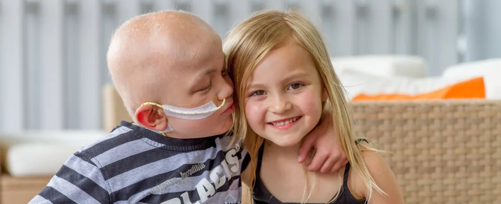 Two children sharing a supportive moment at Ronald McDonald House.